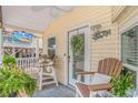 Relaxing porch area with outdoor seating and a ceiling fan at 6001-N2 S Kings Hwy., Myrtle Beach, SC 29575