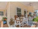 Relaxing porch area with outdoor seating and a ceiling fan at 6001-N2 S Kings Hwy., Myrtle Beach, SC 29575