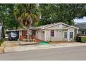 Charming home with a lush palm tree and pink shutters, offering a cozy coastal vibe at 6001-T3 S Kings Hwy., Myrtle Beach, SC 29575