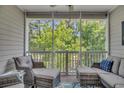 Relaxing screened porch with comfortable seating, offering serene views of the surrounding greenery at 6015 Catalina Dr. # 732, North Myrtle Beach, SC 29582