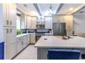 Stylish kitchen with white cabinets, granite countertops, stainless steel appliances, and a center island at 604 Heathrow Dr. # 1097, Myrtle Beach, SC 29579