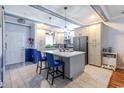 Bright kitchen with a large island, pendant lights, stainless steel appliances and custom cabinetry at 604 Heathrow Dr. # 1097, Myrtle Beach, SC 29579