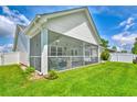 Relaxing screened porch showcasing comfortable seating, ideal for enjoying the outdoors, overlooking large backyard with lush green grass at 631 Rycola Circle, Surfside Beach, SC 29575