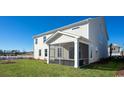 Spacious backyard featuring a screened-in porch, perfect for outdoor relaxation at 7139 Shooting Star Way, Myrtle Beach, SC 29579