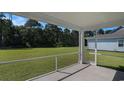 The screened back porch provides great views to the spacious backyard with beautiful green grass at 727 Rupert Dr, Conway, SC 29526