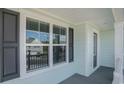The front porch offers a view from a window with black shutters and light blue siding at 727 Rupert Dr, Conway, SC 29526