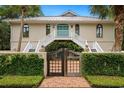 Beautiful home featuring a charming gated entrance with brick pathway and lush greenery at 95 Sanderling Ave., Georgetown, SC 29440