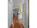 Hallway with wood floors leading to a bright living area and a glimpse of a yellow wall at 100 Lazy Willow Ln. # 103, Myrtle Beach, SC 29588