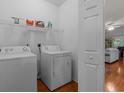 Laundry room with white washer and dryer and a view of the living room at 100 Lazy Willow Ln. # 103, Myrtle Beach, SC 29588
