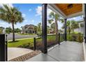 Inviting front porch view with black metal railings, palm trees and neatly landscaped yard at 1058 East Isle Of Palms Ave., Myrtle Beach, SC 29579