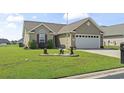 Inviting single-story home with manicured lawn and garden bed leading up to the front door at 1068 Lizzie Ln., Surfside Beach, SC 29575