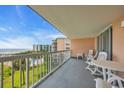 Open-air balcony with white railing and furniture offers views of the pool, grounds and ocean beyond at 145 South Dunes Dr. # 308, Pawleys Island, SC 29585