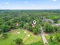 Breathtaking aerial view of property near golf course showcasing lush surroundings and peaceful community at 1501 Harbor Dr., North Myrtle Beach, SC 29582