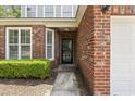 Close up of the red brick entrance showcasing manicured greenery and detailed architectural features at 1535 Harlow Ct., Myrtle Beach, SC 29579
