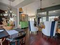 Open concept, high ceilings, dark wood floors, and stylish furniture create an inviting dining area at 1635 Southwood Dr., Surfside Beach, SC 29575