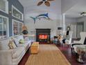 Cozy living room boasts a fireplace, high ceilings, dark wood floors and stylish nautical decor at 1635 Southwood Dr., Surfside Beach, SC 29575