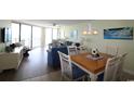 Bright condo living room featuring ocean views, comfortable seating and a dining area with seating for four at 1690 N Waccamaw Dr. # 504, Garden City Beach, SC 29576