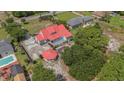 Aerial view of a property featuring a red metal roof, spacious yard, and additional structures at 1700 Longleaf Dr., Myrtle Beach, SC 29575