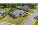 Beautiful aerial view showcasing a brick home, lush landscaping, and a serene backyard pool oasis at 2060 Woodburn Dr., Myrtle Beach, SC 29579