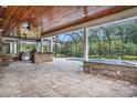 Inviting outdoor patio with a built-in grill, stone bar, ceiling fans, and a screened pool area at 2060 Woodburn Dr., Myrtle Beach, SC 29579