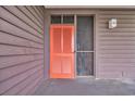 Condo entrance featuring a vibrant orange door and number 342 with brown siding at 207 N Ocean Blvd. # 342, North Myrtle Beach, SC 29582