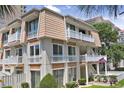 Charming multi-story villa with balconies, manicured lawn, and vibrant landscaping at 211 76Th Ave. N # A3, Myrtle Beach, SC 29572