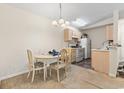 Eat-in kitchen with white appliances, light wood cabinetry, and dining area at 2280 Andover Dr. # L, Surfside Beach, SC 29575
