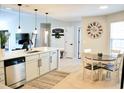 Bright eat-in kitchen with stainless appliances, stylish lighting, and a view to the living area at 230 Vermillion Dr., Little River, SC 29566