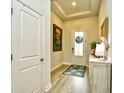 Bright entryway with tray ceiling, white door with glass and a decorative rug at 234 Rolling Woods Ct., Little River, SC 29566