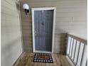 This is an eye-level shot of a front door with a welcome mat, with outdoor light at 300-J Myrtle Greens Dr. # J, Conway, SC 29526