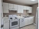 Close-up of a kitchen with white cabinetry, appliances, countertop, and stainless steel sink at 300-J Myrtle Greens Dr. # J, Conway, SC 29526