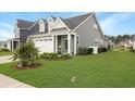 Well-maintained home with lush green lawn and a welcoming, landscaped yard at 312 Goldenrod Circle, Little River, SC 29566
