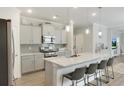 Modern kitchen with a large island, granite countertops, and stainless steel appliances at 312 Goldenrod Circle, Little River, SC 29566