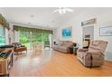 Bright living room featuring a vaulted ceiling, hardwood floors, and sliding glass doors to the backyard at 396 Mckendree Ln., Myrtle Beach, SC 29579
