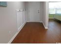 Inviting entryway featuring wood floors, white trim, and a convenient coat rack at 401 Quinta St., Longs, SC 29568