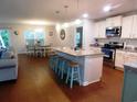 Open-concept kitchen with granite countertops, a breakfast bar, and stainless steel appliances at 401 Quinta St., Longs, SC 29568