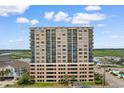 Multi-story condominium building with balconies showcases coastal living near green marshy area at 4103 N Ocean Blvd. # 707, North Myrtle Beach, SC 29582