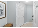 Inviting condo hallway with neutral paint, tiled floor, and closed front door at 4103 N Ocean Blvd. # 707, North Myrtle Beach, SC 29582