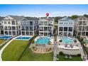 An aerial view of the well-appointed homes, each featuring a unique in-ground pool and outdoor living area at 433 Saint Julian Ln., Myrtle Beach, SC 29579