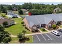 Community aerial view with a swimming pool, tennis court and well manicured lawns at 4648 Lightkeepers Way # 39A, Little River, SC 29566