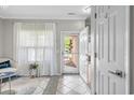 Inviting condo foyer with decorative tile flooring, light gray walls, and an abundance of natural light at 4648 Lightkeepers Way # 39A, Little River, SC 29566