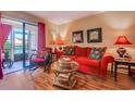 Comfortable living room with a red sofa, wicker table, and access to an outdoor patio at 510 Fairwood Lakes Dr. # 15-I, Myrtle Beach, SC 29588