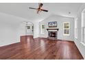 Bright living room featuring vaulted ceiling, shiplap accent wall, and a brick fireplace at 553 Fox Chase Dr., Conway, SC 29527