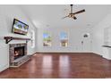 Inviting living room with a brick fireplace, hardwood floors, and lots of natural light at 553 Fox Chase Dr., Conway, SC 29527