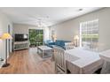 Cozy living room featuring wood-style floors, comfortable seating, and a sliding glass door to the patio at 562 Blue Stem Dr. # 54-F, Pawleys Island, SC 29585