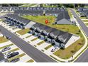 An aerial view of a modern neighborhood featuring townhomes, green spaces, and ample parking at 563 Sea Sparrow St. # 563, Myrtle Beach, SC 29588