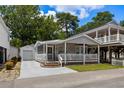 Charming coastal home featuring a screened porch, picket fence, and detached garage at 6001 - 5442 S Kings Hwy., Myrtle Beach, SC 29575