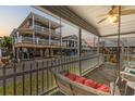 Relax on this porch swing with views of the neighborhood and coastal homes at 6001 - 5442 S Kings Hwy., Myrtle Beach, SC 29575