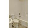 Clean, all-white bathroom with standard fixtures including a toilet, sink, and tub-shower combo at 601 Putters Ln. # H209, Little River, SC 29566