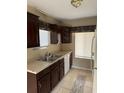 Efficient kitchen with dark wood cabinets, and a stainless steel sink at 615 Todd Blvd., Conway, SC 29526